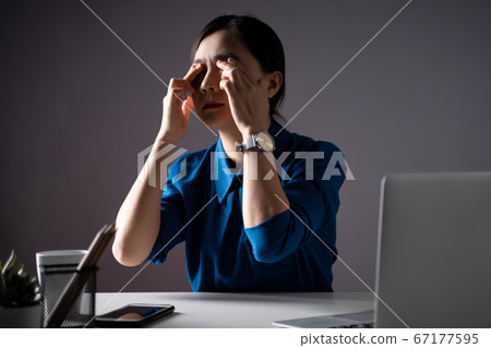 Asian woman in blue shirt was sick with eye pain Asian woman in blue shirt was sick with eye pain 67177595