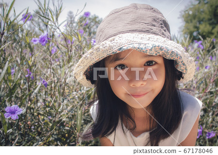 close up of Asian little girl a pose in the park close up of Asian little girl a pose in the park 67178046