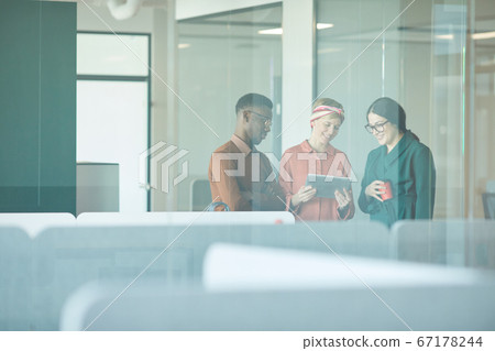 Ethnic Team Behind Glass in Modern Office 67178244
