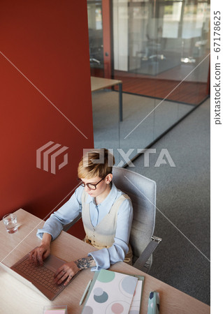 Tattooed Young Woman at Workplace High Angle Tattooed Young Woman at Workplace High Angle 67178625
