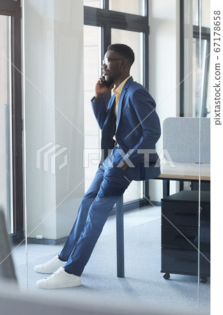 Elegant African Businessman Speaking by Smartphone Elegant African Businessman Speaking by Smartphone 67178658