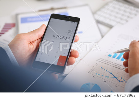 Smartphone calculator and financial statistics on infographics Smartphone calculator and financial statistics on infographics 67178962