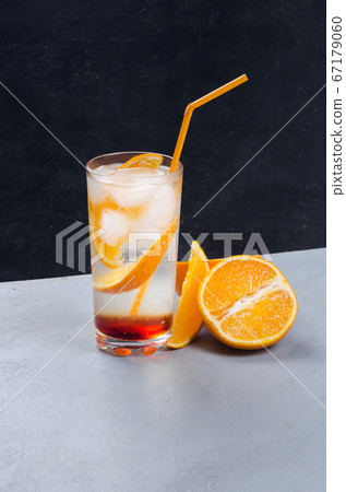 Orange alcohol cocktail with orange fruit slice on dark background Orange alcohol cocktail with orange fruit slice on dark background 67179060