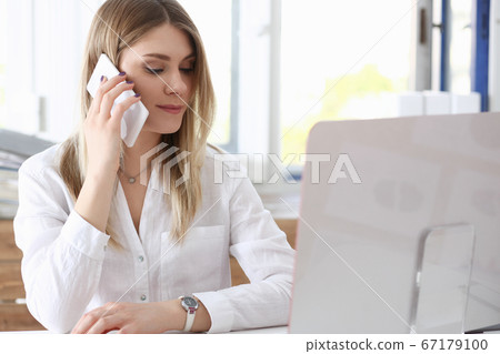 Beautiful blonde smiling businesswoman talk cellphone Beautiful blonde smiling businesswoman talk cellphone 67179100