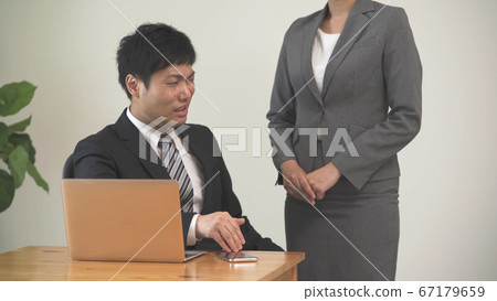 Businessman scolding a businesswoman Businessman scolding a businesswoman 67179659