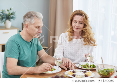 Mature Married Couple at Dinner Table Mature Married Couple at Dinner Table 67180060