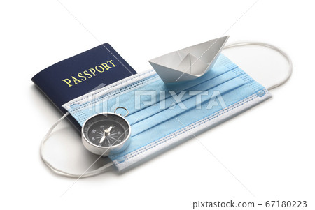 Summer holiday during pandemic crisis. Mask with white paper ship and passport on white background. Summer holiday during pandemic crisis. Mask with white paper ship and passport on white background. 67180223