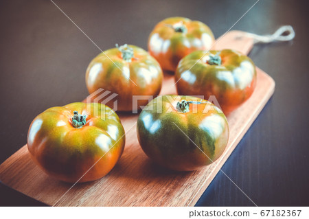 Black Krim organic tomatoes on a cutting board 67182367