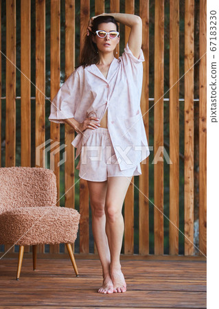 Woman in pajamas over wooden background on terrace. Good morning concept. 67183230