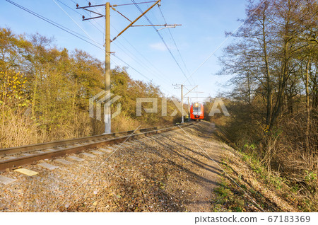 railway tracks go into the distance, the train at 67183369
