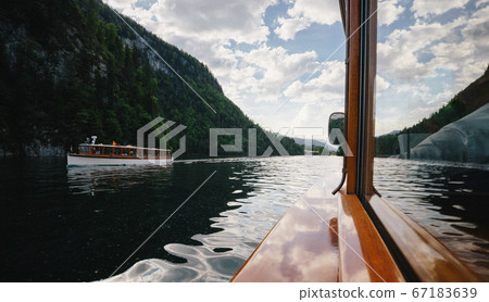 Traditional passenger boats on Konigssee lake in the Bavarian Alps, Germany Traditional passenger boats on Konigssee lake in the Bavarian Alps, Germany 67183639