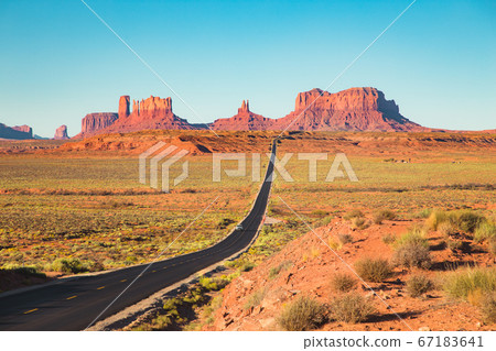 Classic highway view in Monument Valley at sunset, Utah, USA 67183641