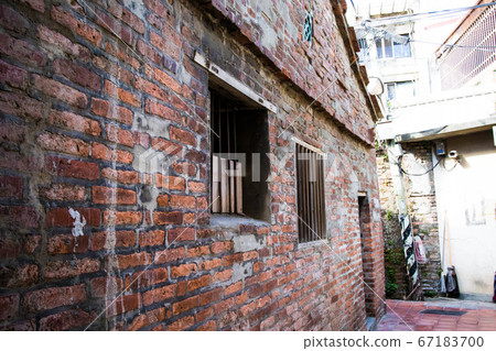 An obsolete warehouse of old red bricks in the back alley An obsolete warehouse of old red bricks in the back alley 67183700