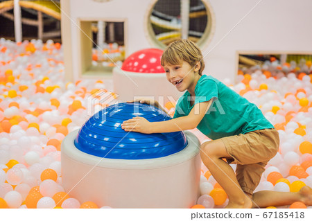 The boy has fun in an indoor playground 67185418