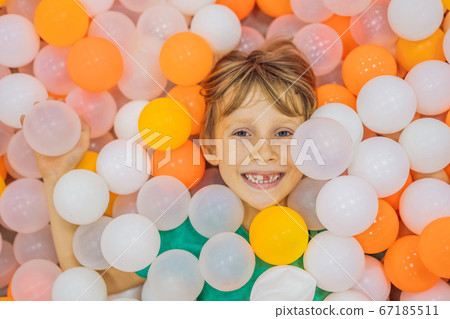 Child playing in ball pit. Colorful toys for kids. Kindergarten or preschool play room. Toddler kid at day care indoor playground. Balls pool for children. Birthday party for active preschooler 67185511
