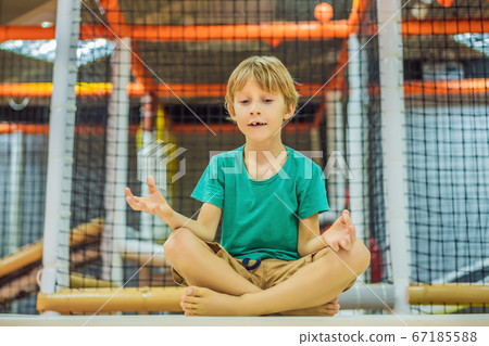 The boy has fun in an indoor playground 67185588