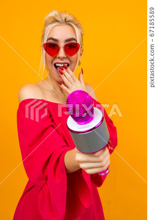 Sexy girl in a red dress celebrates a birthday and sings in karaoke 67185589