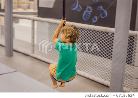 The boy has fun in an indoor playground 67185624