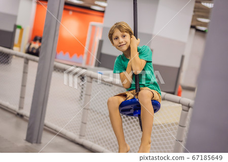 The boy has fun in an indoor playground 67185649