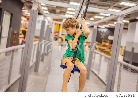 The boy has fun in an indoor playground The boy has fun in an indoor playground 67185681