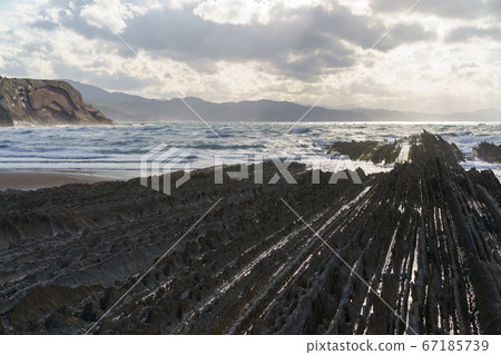 Breathtaking sescape in Basque Autonomous Community / country in summer cloudy day. Wide Atlantic ocean coast at low tide in Bay of Biscay. Charming Zumaia Itzurun beach. High resolution image. 67185739