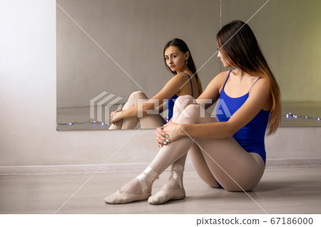 A young woman is engaged in stretching in the gym A young woman is engaged in stretching in the gym 67186000