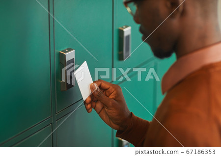 African-American Man Opening Locker African-American Man Opening Locker 67186353