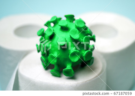 Green model of coronavirus on the toilet paper roll 67187059