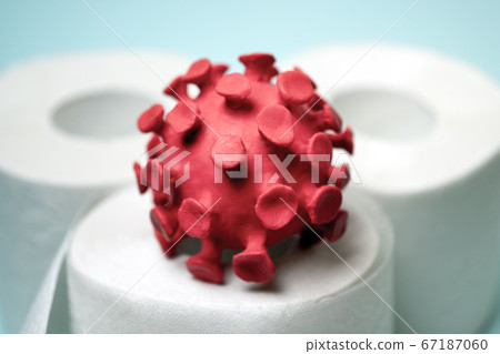 Red model of coronavirus on the toilet paper roll 67187060