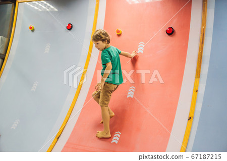 The boy has fun in an indoor playground 67187215
