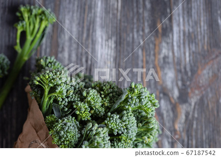Bunch of broccolini on wooden table. Bunch of broccolini on wooden table. 67187542