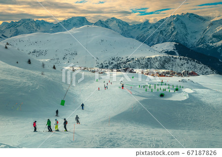 Winter ski resort with skiers in snow park, France, Europe 67187826