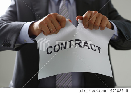 Male hands are tearing contract paper in the office 67188546
