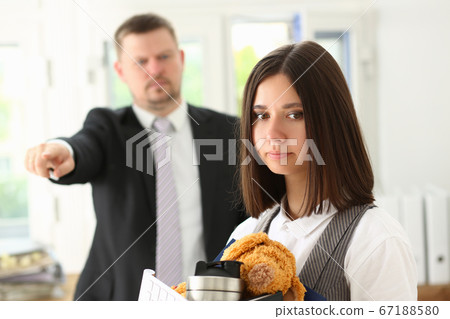 Female office worker getting fired from job Female office worker getting fired from job 67188580