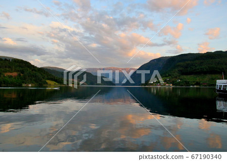 Norwegian Hardanger Fjord, Ulvic District Overlooking the water and mountains of the sunset clouds near the twilight south of the hotel Norwegian Hardanger Fjord, Ulvic District Overlooking the water and mountains of the sunset clouds near the twilight south of the hotel 67190340