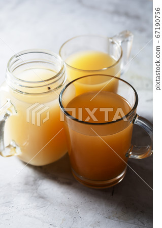 Homemade Beef Bone Broth in Glasses on a gray 67190756