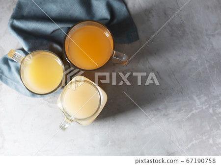 Homemade Beef Bone Broth in Glasses on a gray Homemade Beef Bone Broth in Glasses on a gray 67190758