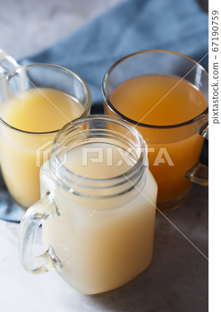 Homemade Beef Bone Broth in Glasses on a gray Homemade Beef Bone Broth in Glasses on a gray 67190759