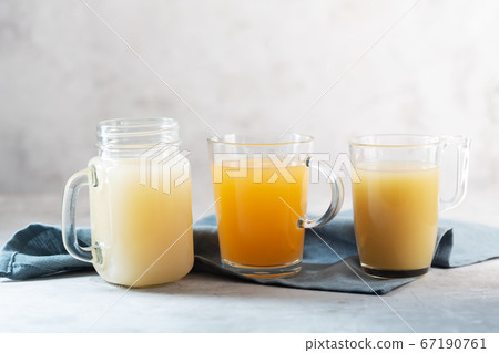 Three types of Homemade Beef Bone Broth in Glasses 67190761