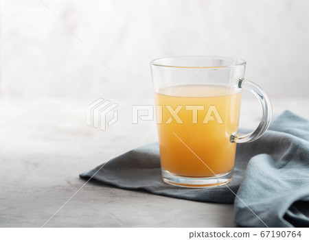 Homemade Beef Bone Broth in Glasses on a gray Homemade Beef Bone Broth in Glasses on a gray 67190764