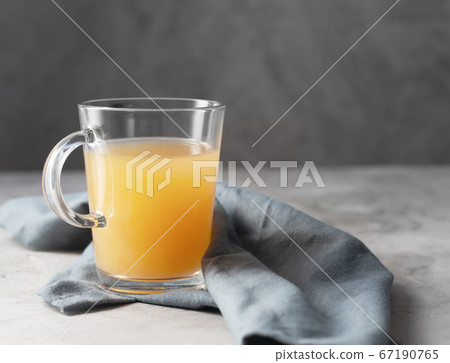 Homemade Beef Bone Broth in Glasses on a gray Homemade Beef Bone Broth in Glasses on a gray 67190765