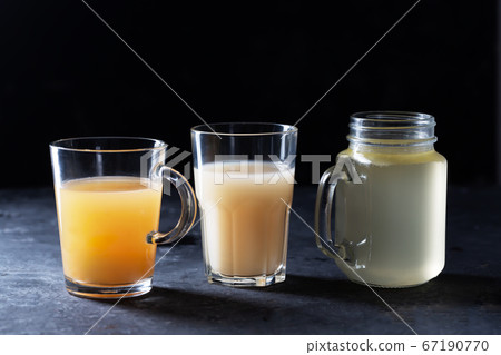 Three types of Homemade Beef Bone Broth in Glasses 67190770