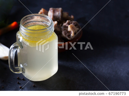 Homemade Beef Bone Broth in Glass Storage Jar on a Homemade Beef Bone Broth in Glass Storage Jar on a 67190773