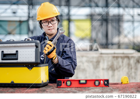 Maintenance worker preparing work tool at site Maintenance worker preparing work tool at site 67190822
