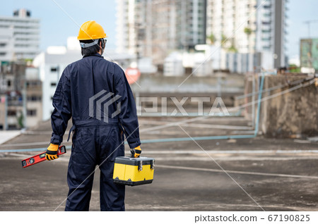Worker man carrying work tool at construction site Worker man carrying work tool at construction site 67190825