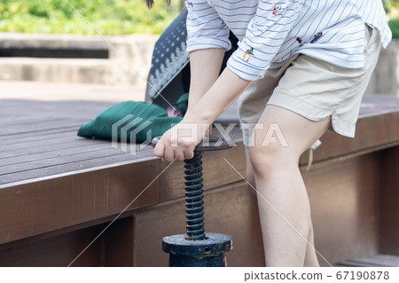 Woman turning the water supply valve 67190878