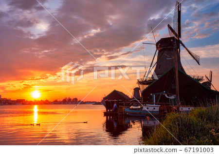 Windmills at Zaanse Schans in Holland on sunset. Zaandam, Nether Windmills at Zaanse Schans in Holland on sunset. Zaandam, Nether 67191003