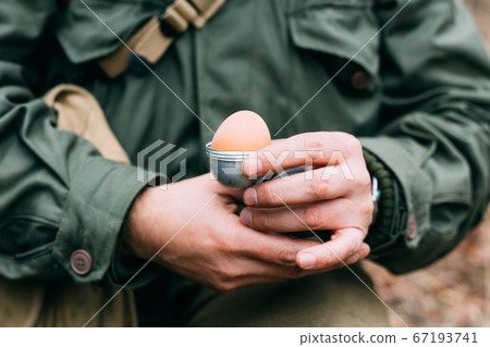 Soldier Of USA Infantry Of World War II Holds Egg Holder In Hands During Breakfast. 67193741