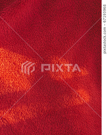 Red blanket texture on the sunlight 67193968
