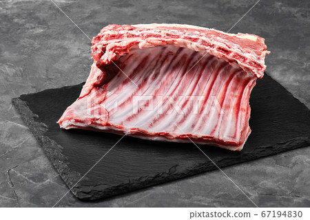 Lamb ribs fresh meat, with eco-friendly packaging. Food Delivery Concept. copy space, dark background Lamb ribs fresh meat, with eco-friendly packaging. Food Delivery Concept. copy space, dark background 67194830